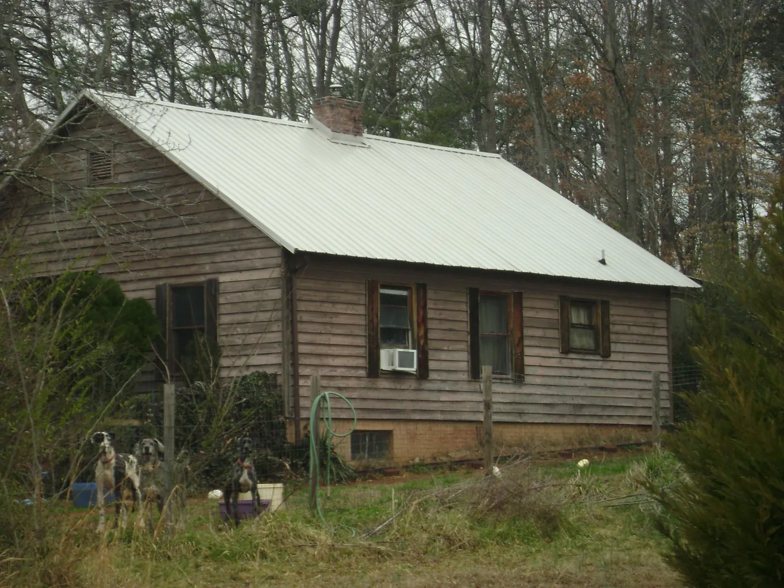 White metal roof on an old wood sided farmhouse, from a Asphalt Shingle Roof Repair job in Paramus